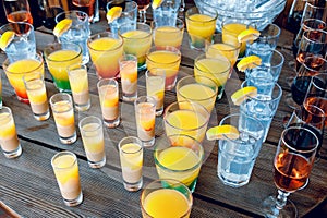 Colorful cocktails in glass glasses on a wooden dark table. Drink