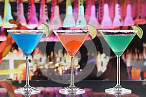 Colorful cocktails in Martini glasses in a bar