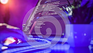 Colorful coding workspace with hand on keyboard