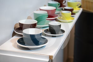 Colorful coffee cups lined up on the table