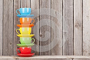 Colorful coffee cups on shelf