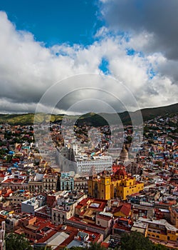 Colorful colonial crowd American city and church in hill, Guanajuato, Mexico photo