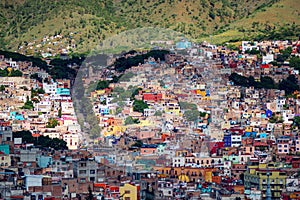 Colorful colonial crowd American city and buildings in hill, Guanajuato, Mexico photo