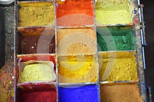 Colorful color powder pigments at a workplace of an artist