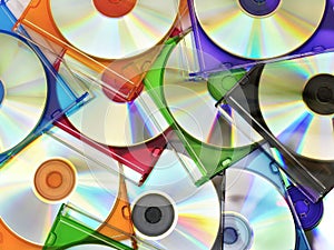 Colorful compact discs in boxes stacked in a pile as background