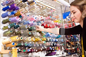 Colorful cones and spools of thread at an atelier.Tailoring, garment industry, designer workshop concept.