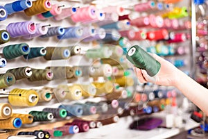 Colorful cones and spools of thread at an atelier.Tailoring, garment industry, designer workshop concept.