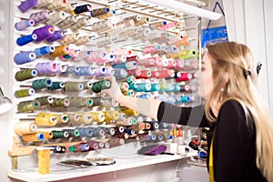 Colorful cones and spools of thread at an atelier.Tailoring, garment industry, designer workshop concept.