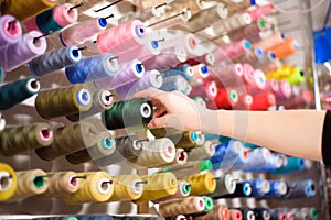 Colorful cones and spools of thread at an atelier.Tailoring, garment industry, designer workshop concept.