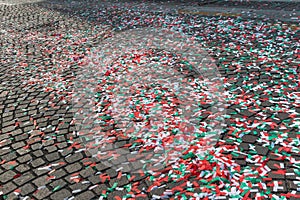 Colorful Confetti on Cobblestone Road in City Street