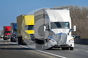 Colorful Convoy of Heavy Semi Trucks On Highway