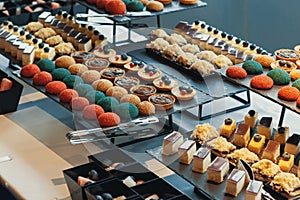 Colorful cookies, biscuits and cakes presented at business conference or coffee break