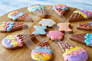 Colorful cookies on wooden board.