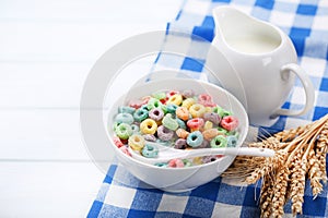 Colorful corn rings in bowl with milk