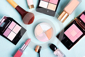 Colorful cosmetics set on blue background.