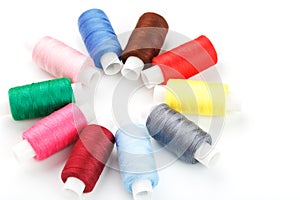 Colorful cotton craft sewing threads in flower shape isolated on white background