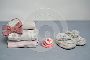 Colorful cotton folded clothes stack on white table empty space background,baby laundry.