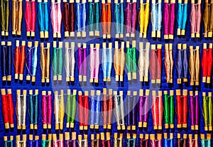 Colorful cotton reels laying organized side by side