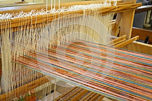 Colorful cotton threads on traditional weaving machine