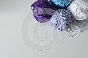 Colorful cotton yarn balls for handmade on white table background with copy space.