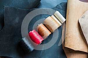 Colorful crafts thread on vegetable tanned leather background