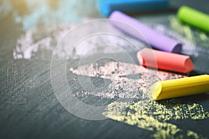 Colorful crayons on the blackboard, drawing. Back to school background.