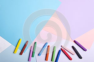 Colorful crayons on the bright paper.Empty space for design photo