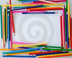 Colorful crayons on checked paper