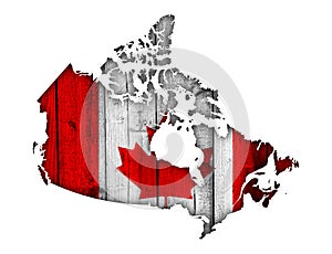 Map and flag of Canada on weathered wood