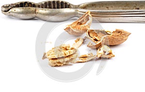 Walnuts cracked with nutcracker on white