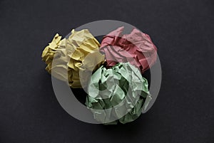 A colorful crumpled paper balls on a black background