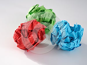 Colorful crumpled paper balls on a gray background