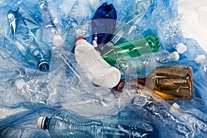 Colorful crumpled wasted bottles lying in a pile