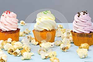 Colorful cupcakes on a wooden background