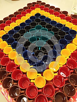 Colorful cups displayed in crockery store