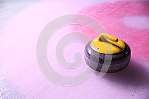 Colorful curling stones on ice