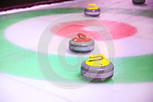 Colorful curling stones on ice