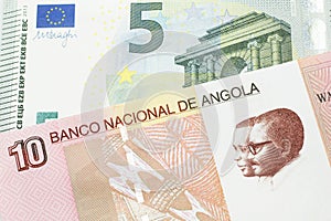 Colorful currency from Angola with European money