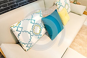 Colorful cushion pillows on modern beige color fabric sofa interior for office building or home and living achitecture decoration