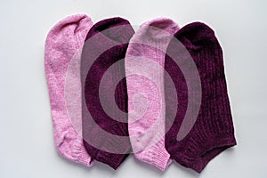 Colorful dark red and pink woman socks arranged in a row