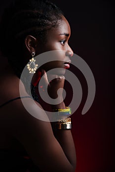 Colorful and dark side view portrait of native african woman