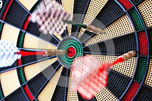 Colorful darts board close up with arrows in the bullseye