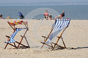 Colorful deckchairs on beach photo