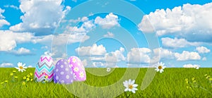 Colorful Decorated Easter Eggs on Green Meadow with Beautiful Blue Sky Clouds Background 3d render