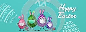 Colorful decorated eggs with rabbit ears in medical masks happy easter spring holiday coronavirus