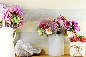 Colorful decoration artificial flower bouquet and bird statue on wooden Shelves
