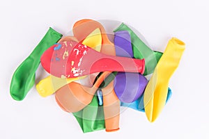 Colorful deflated balloons on white background