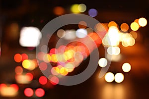 Colorful defocused bokeh traffic lights in city night background