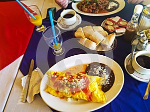 Colorful, delicious Mexican breakfast omlet with beans and rice in resturant