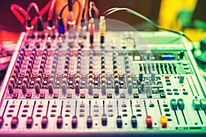 Colorful details of music mixer, buttons on equipment in audio recording studio or nightclub